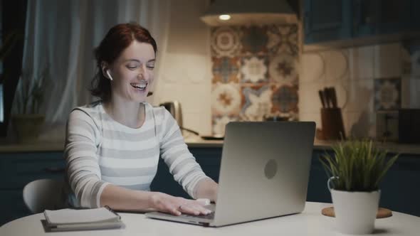 Woman In The Kitchen With Laptop, She Smiles