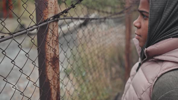 Refugee Girl at Barbed Wire fence