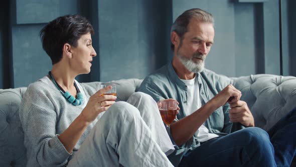 Aged Couple Drinking Wine