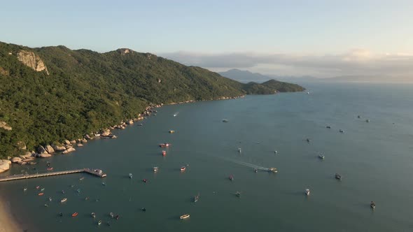 Small Boats Anchored in the Sea with Green Mountain Coastline, Aerial.