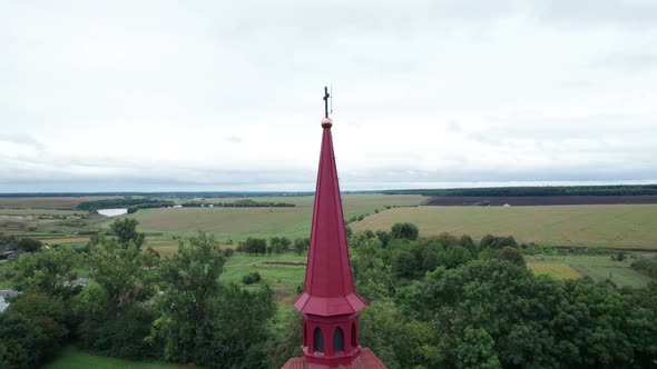 Towering Spires Atop the Roman Catholic Church on Countryside Background