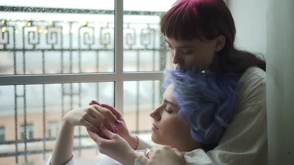 Portrait of Two Cute Lesbian Young Womanfriends Holding Hands Gently Spbd