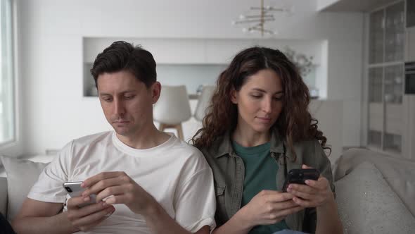 Newlyweds Relax Scrolling Through Social Media with Phones