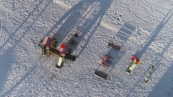 Top down aerial view of empty small kid games playground in winter 19