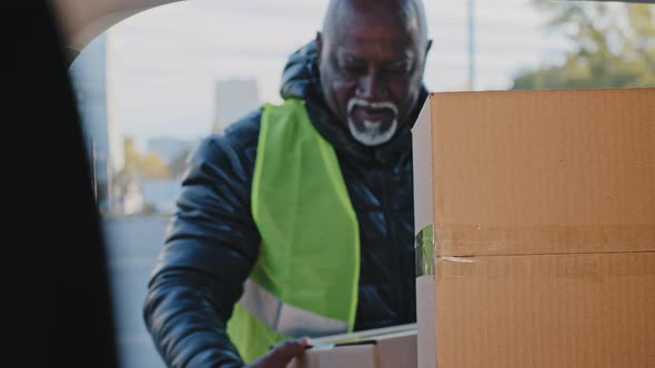 Mature African American Man Experienced Courier Loader Delivery Worker Handyman in Uniform Outdoors