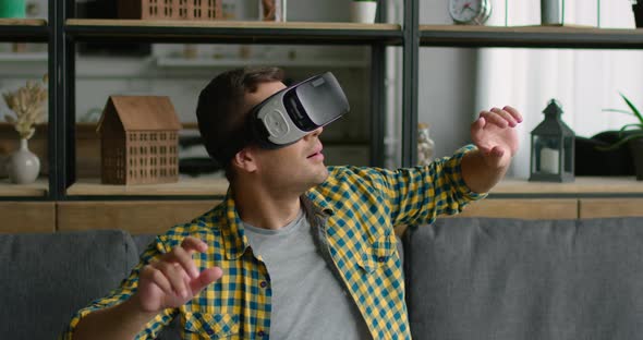 Young Man Has Fun By Wearing Virtual Reality Headset