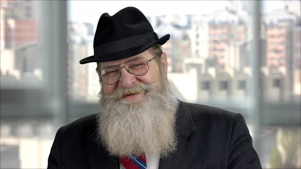 Portrait of and Old Smiling Longbearded Mister with Black Hat and Jacket