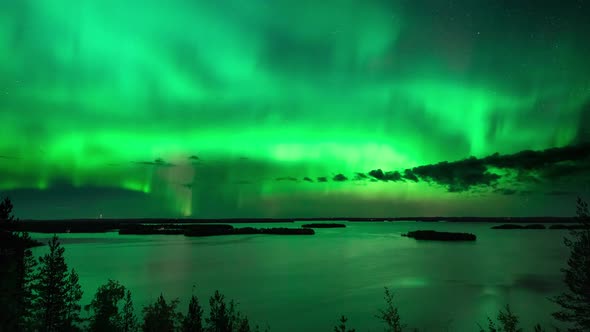 Timelapse of aurora borealis, a magnetic solar phenomenon, above lake Hoytianen, on a cold autumn ni