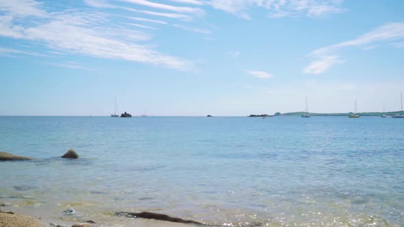 Peaceful view of crystal blue waves from an Isles of Scilly beach, Cornwall.