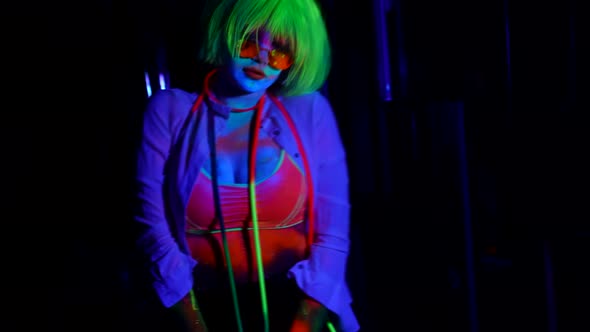 Gogo Dancer Woman in Nightclub Woman with Fluorescent Makeup and Neon Wig