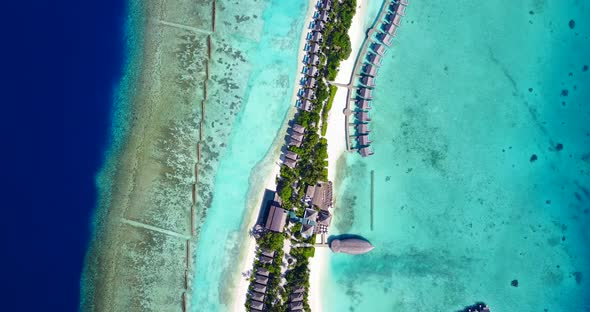 Wide angle birds eye copy space shot of a sunshine white sandy paradise beach and blue water backgro