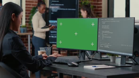 Asian Programer Writing Code in Front of Computer with Green Screen Chroma Key Mockup