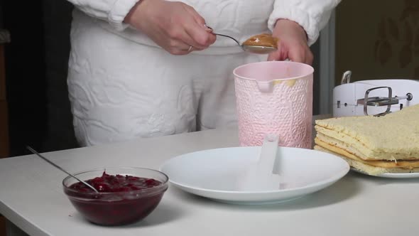 A Woman Puts Boiled Condensed Milk Into A Container, Prepares Cream For A Cake