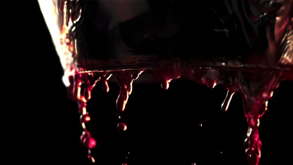 Super Slow Motion Red Wine Flows Down the Walls of the Glass