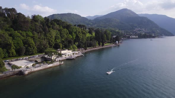 Boat Traveling along Coast of the Beautiful Lake Como, Italy - Aerial