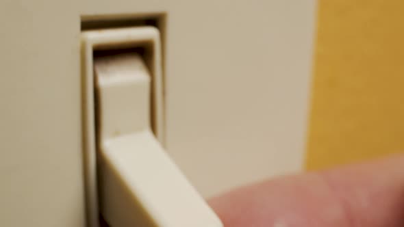 Macro shot of a finger turning on a light switch