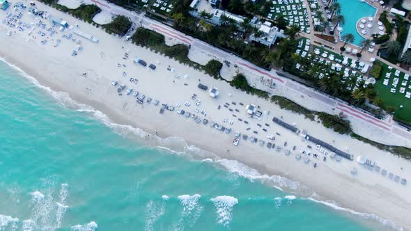 Birdseye View Of Turquoise Ocean With Beautiful Paradise Resorts And Waterfront Hotels At Mid-beach