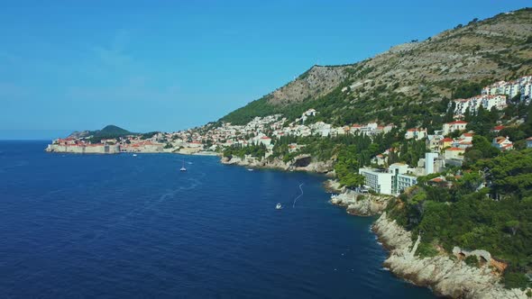 Aerial shot flying over the coast of Dubrovnik with the Adriatic Sea, Croatia