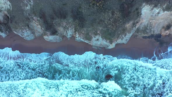 Aerial view to a beautiful wild rocky beach and big waves