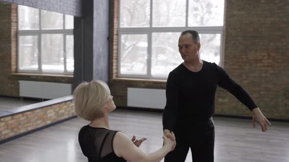 Professional Ball Dancers Practicing in Ballroom