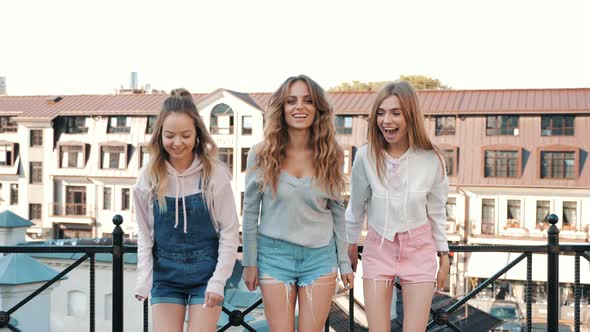 Three young female hipster friends posing outdoors