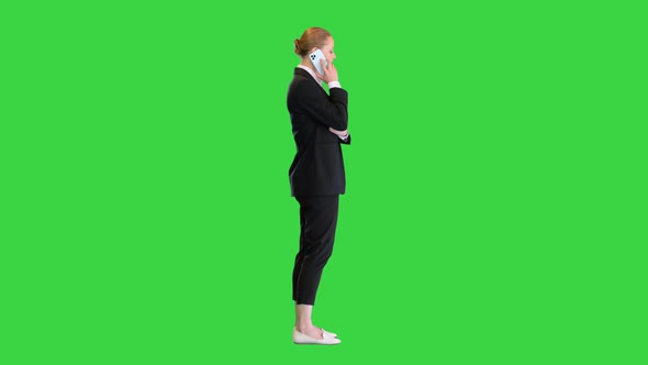 Blonde Businesswoman Having a Phone Call on a Green Screen Chroma Key