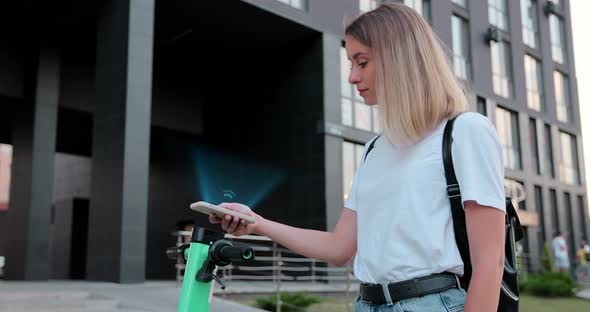 Tourist Woman Take Electric Scooter in Sharing Parking Lot Tourist Phone Application