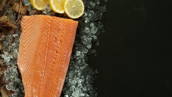 Super Slow Motion Shot of Falling Big Fresh Salmon Steak Into Crushed Ice at 1000 Fps.