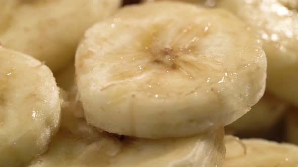 Banana Slices Closeup, Macro Food Summer Background, Fruits Top View. Rotate