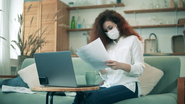 Work From Home During Covid-19 Pandemic. A Woman in a Face Mask Is Working From Home on Quarantine