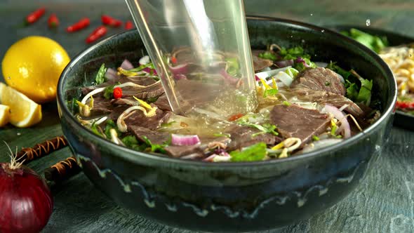 Super Slow Motion Shot of Pouring Beef Broth Into Pho Soup at 1000 Fps