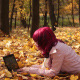 Young Girl with Laptop in Autumn Park - VideoHive Item for Sale