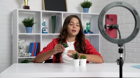 Child Making Video Review on Cactus with Selfie Lamp and Phone Planting Blog