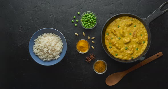 Bubbling hot chicken curry in pan with spices