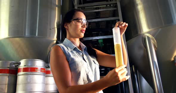 Female brewer testing beer 4k