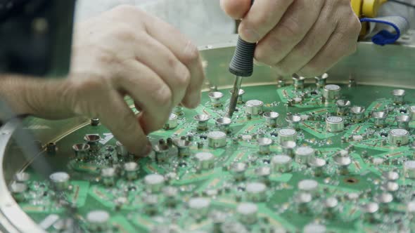 Close up of manual soldering of a large circuit board