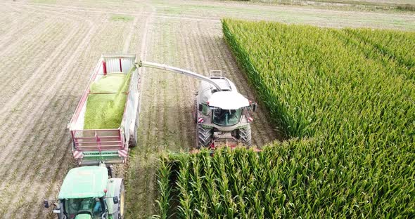 Aerial Drone frontal shot of harvesting machine