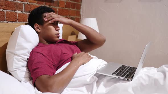 Headache Tired African Man Working on Laptop in Bed