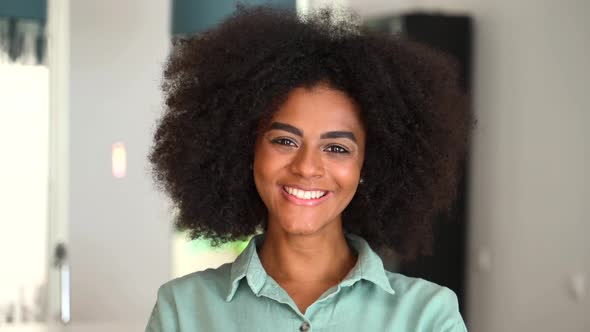 Headshot of a Young African American Ethnic Female with Afro Curly Hairstyle alt