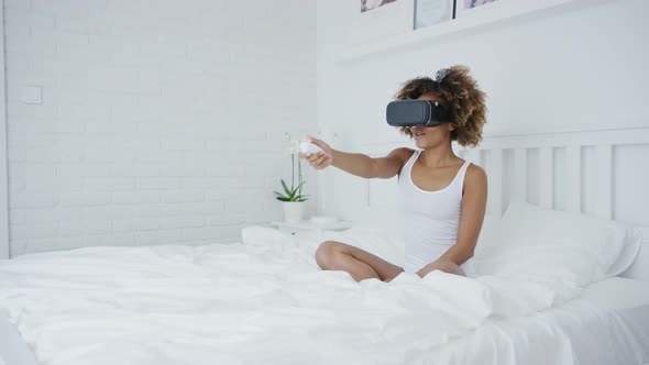 Excited Woman Gaming in VR Glasses