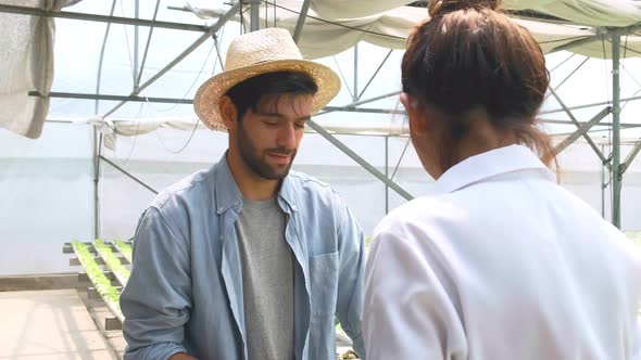 4k slow handheld hydroponic farm owner discuss with female client