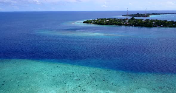 Natural flying island view of a sandy white paradise beach and aqua blue ocean background in vibrant