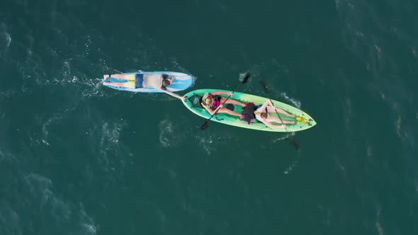 Young Women and Man Enjoying Water Sports Leisure Time on Summer Vacation Shot