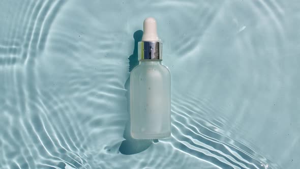 Cosmetic Bottle Vial for Oil Liquid Collagen Serum on Water Surface with Drops