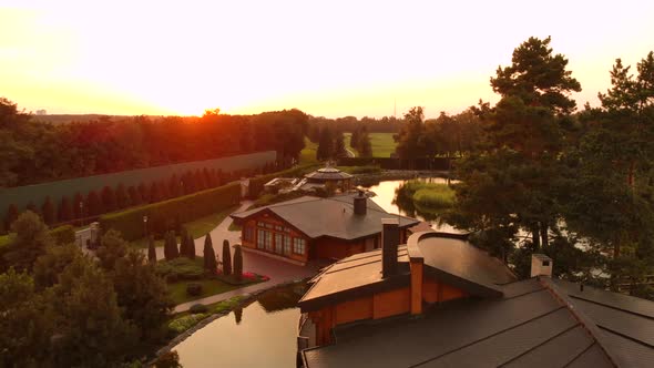 Flying Over Houses Based on the Pond in the Park