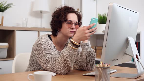 Young Woman Scrolling and Texting Using her Smartphone