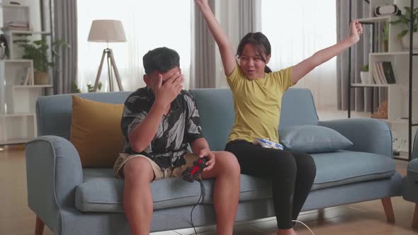 Children With Joystick Game Play Video Game On Tv, Girl Celebrating Victory And Boy Disappointed