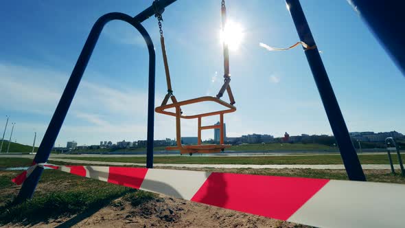 Children's Swings Swaying in the Urban Landscape