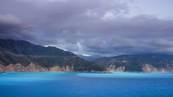 Timelapse of Magic Light and Clouds Crossing the Sky Over the Sea and Rocky Shore. Sunrise or