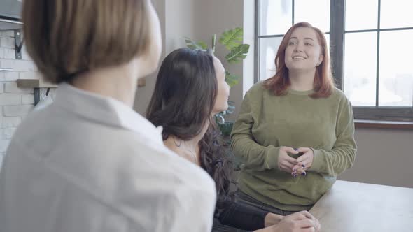 Charming Plussize Redhead Woman Listening To Friend Talking at Front and Smiling